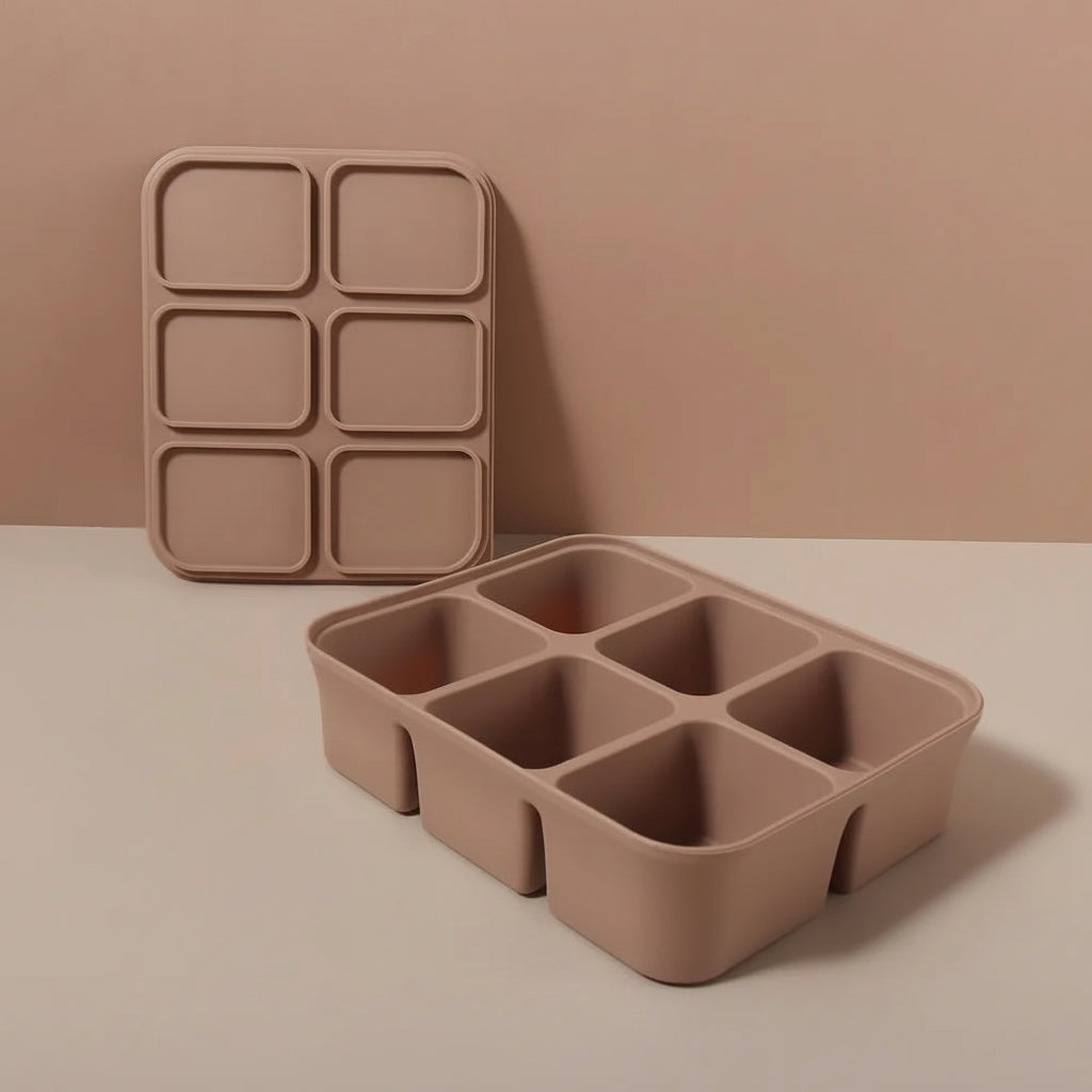 Brown silicone ice tray with six compartments on a beige background