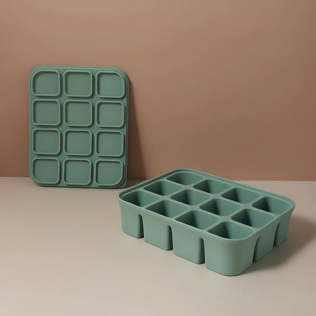 Green silicone ice tray on a beige surface with measurements indicated.