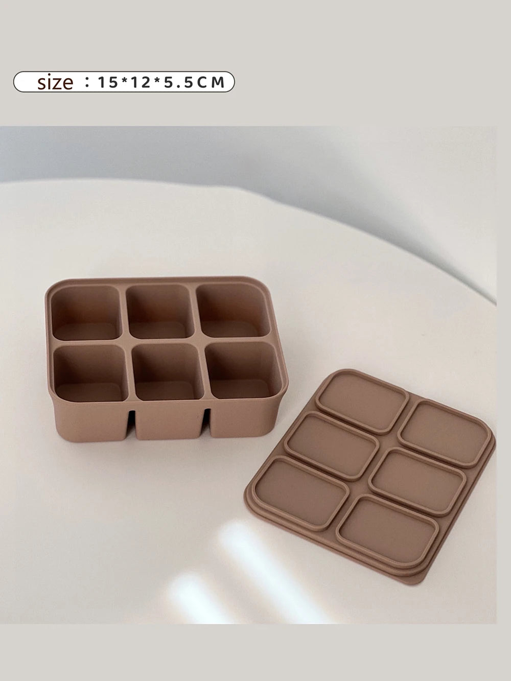 Three pink silicone ice tray with compartmentalization labels on a white background