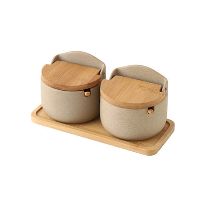 Two ceramic containers with wooden lids on a wooden tray with Chinese text below.